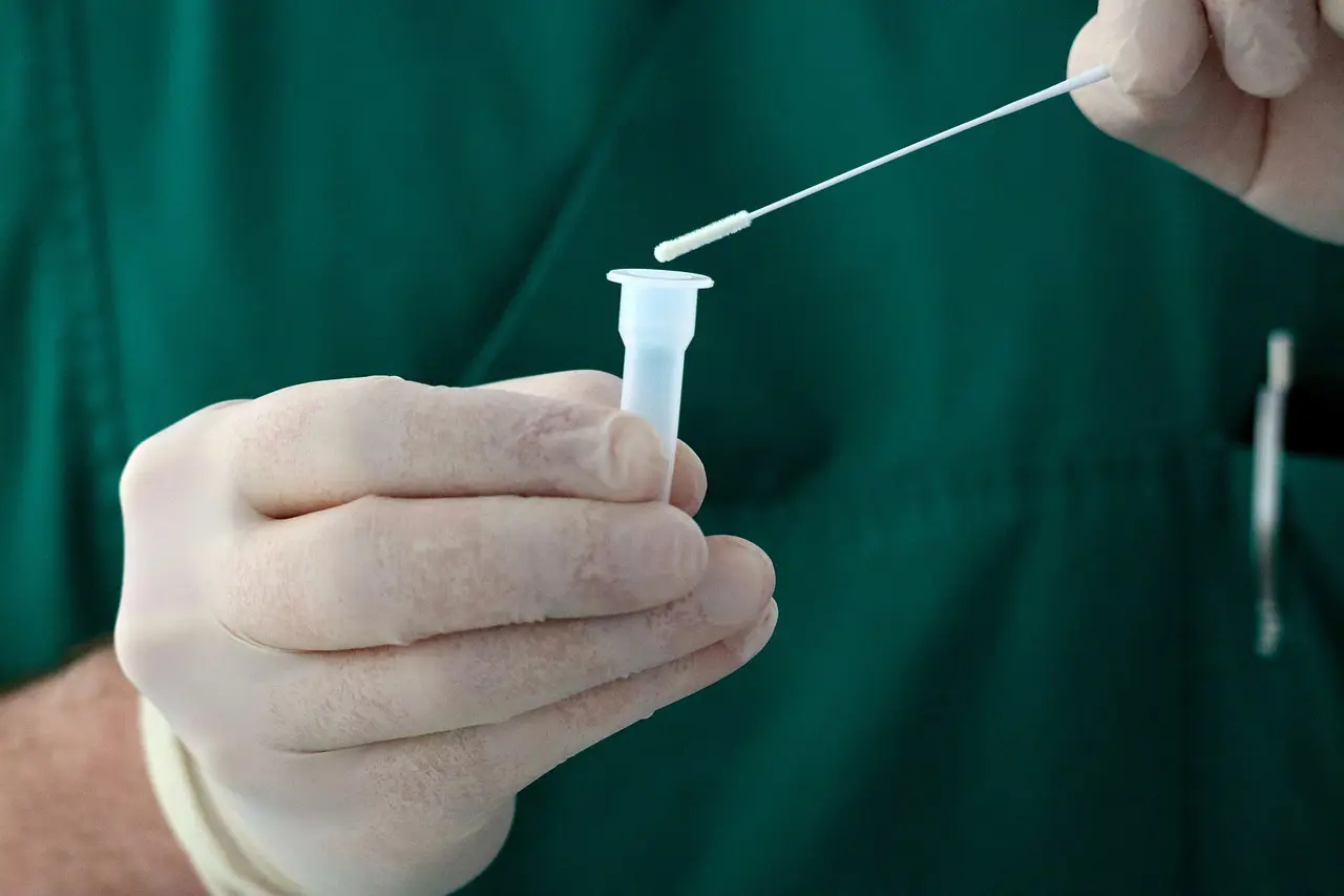 A person holding a needle and a container